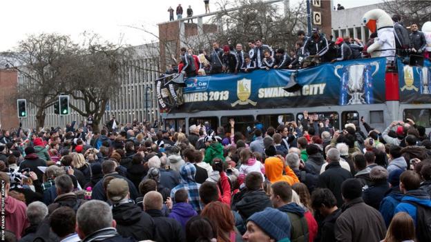 Some Swansea fans find a perch high above the crowds