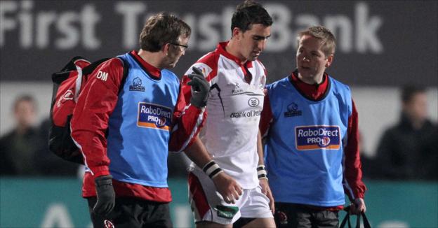 Ruan Pienaar leaves the pitch injured after receiving treatment from Ulster medical staff