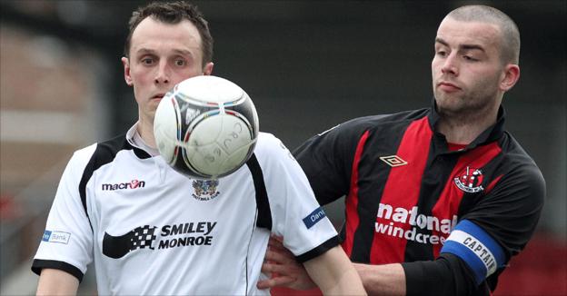 Lisburn Distillery's Michael Halliday and Colin Coates of Crusaders keep their eyes on the ball at Seaview