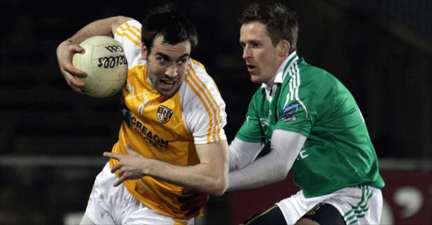 Antrim's Kevin Niblock swivels away from John Woods as Antrim draw with Fermanagh in an Ulster derby in Division Three