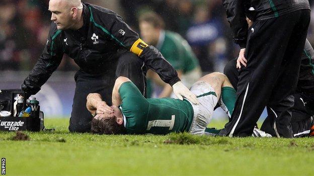 Eoin Reddan lies injured during the Six Nations match against France