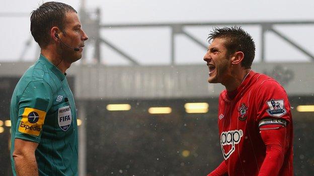 Mark Clattenburg and Adam Lallana