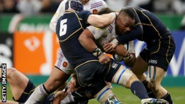 Three Scotland players attempt to stop Mathieu Bastareaud