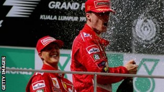 Michael Schumacher (left) celebrates with Eddie Irvine in Malaysia, 1999