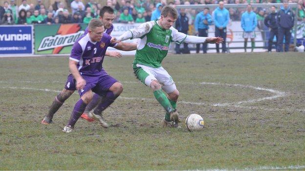 Guernsey FC's Matt Loaring under pressure from Spennymoor Town's Kallum Griffiths and Lewis Dodds