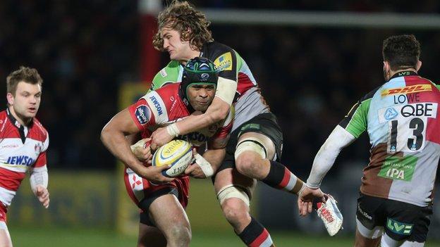 Gloucester's Akapusi Qera is tackled by Quins' Luke Wallace at Kingsholm