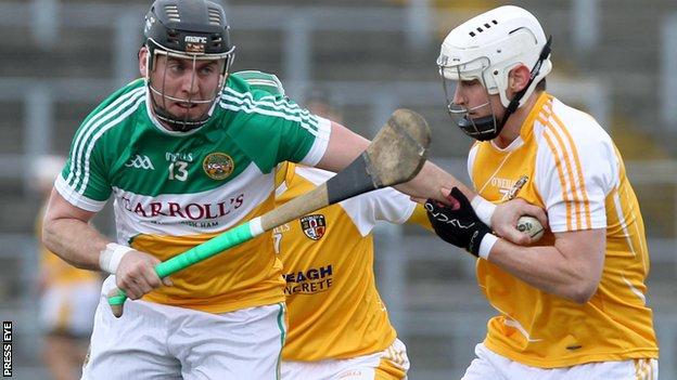 Offaly's Shane Dooley tries to fend off Antrim's Aaron Graffin