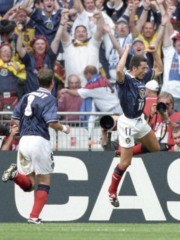Scotland midfielder John Collins (right) celebrates in front of the Tartan Army
