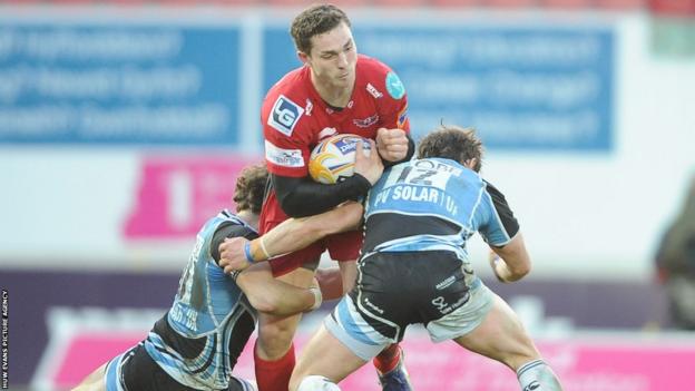 Wing George North, who will leave the Scarlets for Northampton in the summer, is tackled by Glasgow’s Ruaridh Jackson and Peter Horne.