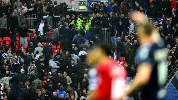 Millwall supporters clash with police