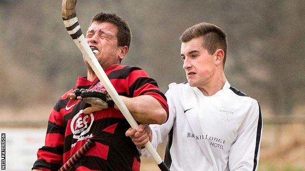 Oban's Ian Campbell winces in a challenge with Lovat's Lewis Tawse