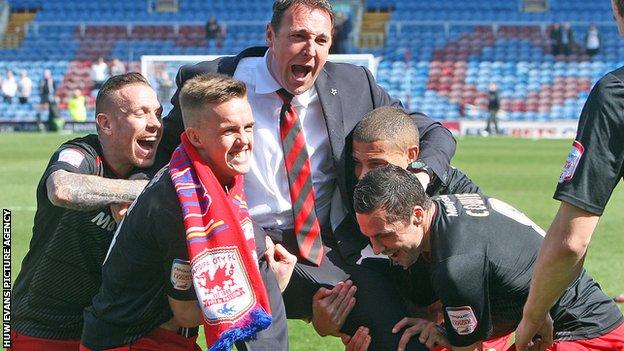 Malky Mackay celebrates winning the Championship title with his players