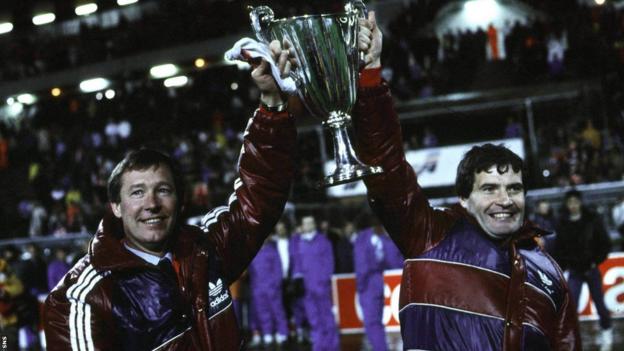 Alex Ferguson and his assistant Archie Knox show off the cup - one of 10 trophies the pair brought to Pittodrie.