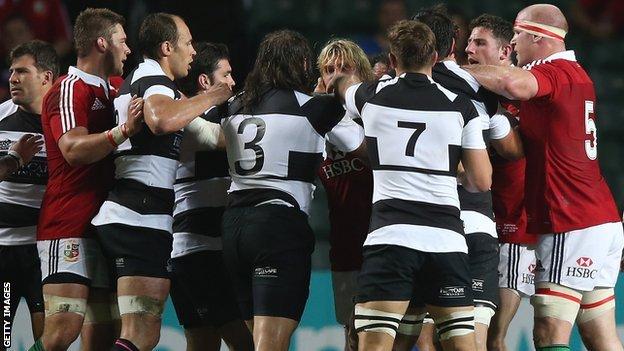 Barbarians and Lions players grapple after Schalk Brits (left) tangled with Owen Farrell