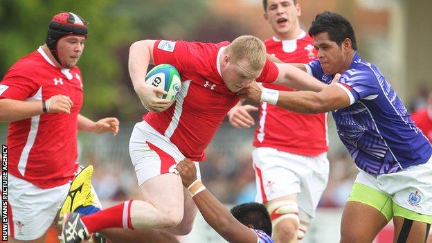 Wales’ Ethan Lewis drives through the Samoan defence during their opening win