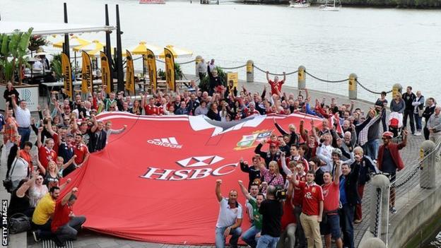 Fans surround a giant Lions shirt in Brisbane