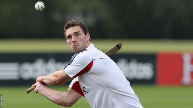 George North tries his hand at hurling after being declared fit to face the Wallabies