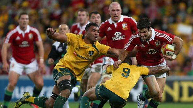 Mike Phillips is tackled by Will Genia