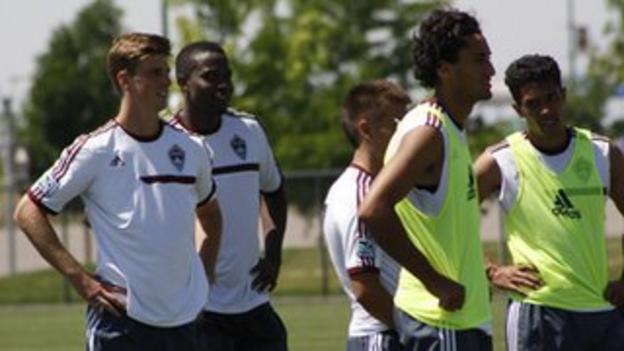 Danny Mwanga (second from left) smiles during a training session for the Rapids