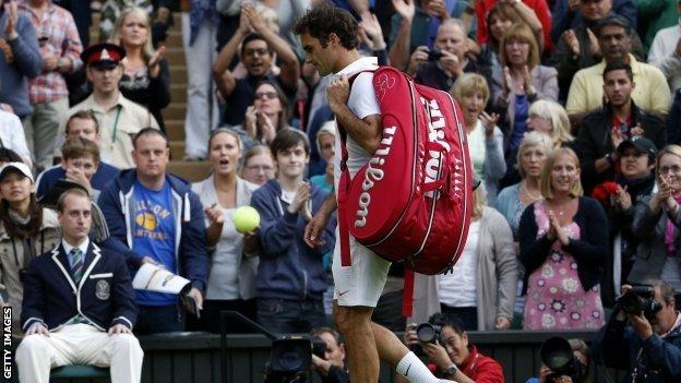 Roger Federer walks off court at Wimbledon 2013