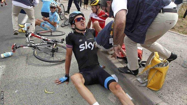 Team Sky rider Geraint Thomas receives attention after crashing