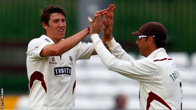 Jamie Overton celebrates with Somerset captain Marcus Trescothick after taking a wicket
