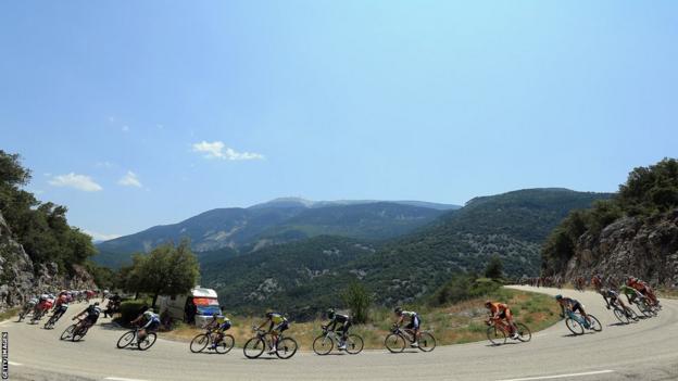 The peloton winds through the hills with Mont Ventoux in the background