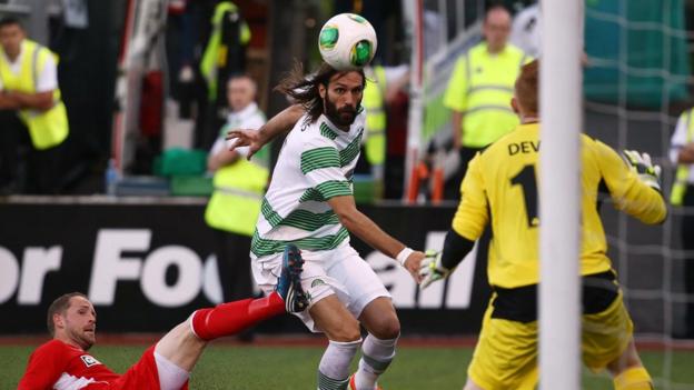 Celtic striker Georgios Samaras closes in on the Cliftonville goal as goalkeeper Conor Devlin prepares for action