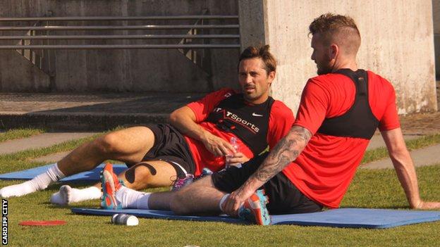 Cardiff City's Tommy Smith and Aron Gunnarsson take a break during training in Lausanne