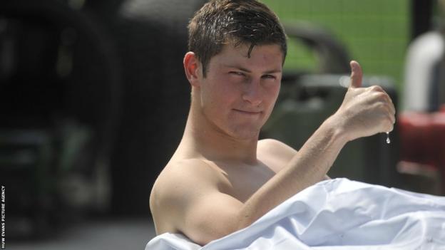 Wales defender Ben Davies cools down in an inflatable ice bath at the side of the pitch at the Swansea City's new training facility