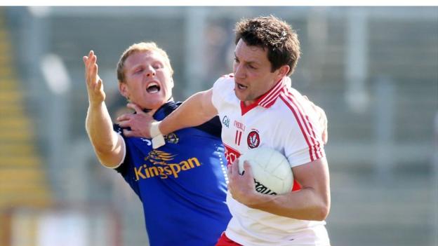 James McEnroe is shrugged off by James Kielt during the All-Ireland third round qualifier Ulster derby