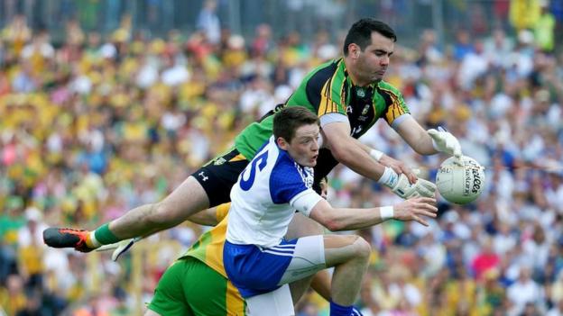 Donegal goalkeeper Paul Durcan reaches the ball ahead of Conor McManus during Monaghan's victory in the senior final