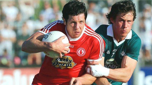 Tyrone's Sean Cavanagh holds off Emmet Bolton in the qualifier win over Kildare