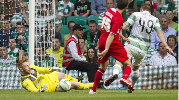 Cliftonville keeper Conor Devlin makes an early save as Celtic look to build on their 3-0 advantage from last week's first leg