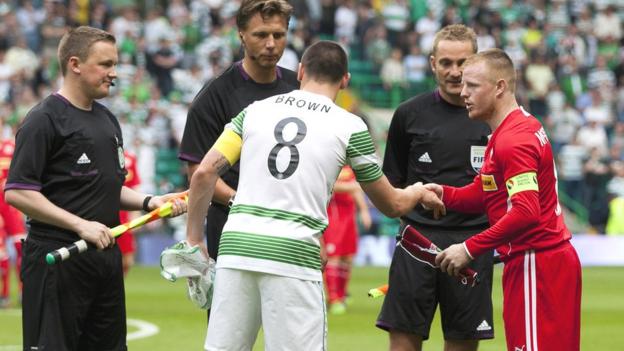Celtic captain Scott Brown and Cliftonville counterpart George McMullan shake hands before the game at Celtic Park