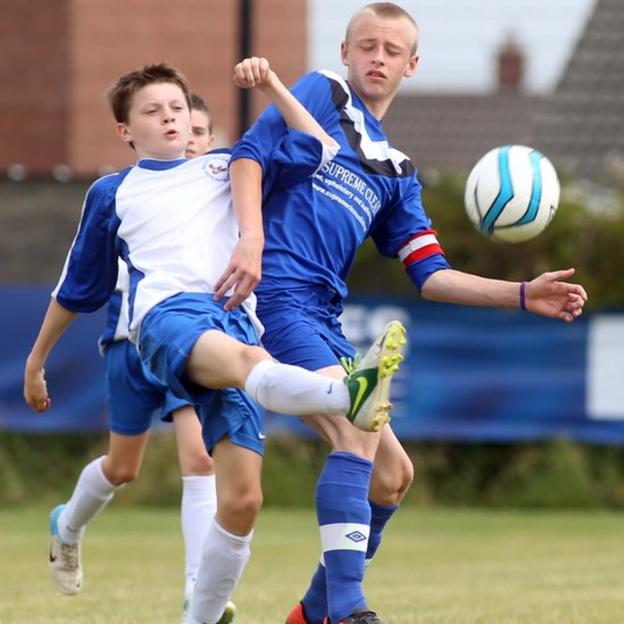 Ballinamallard's Angus Keys competes against Ballymoney's Ryan McCloy in an Under-14 group fixture