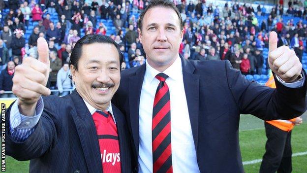 Vincent Tan and Malky Mackay give the thumbs-up to the camera