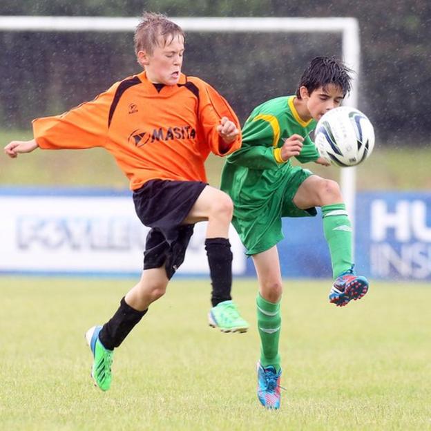 Inishowen's Pat Loughrey and Jonah Serrinah of Donegal Schools in action during an Under-13 section quarter-final