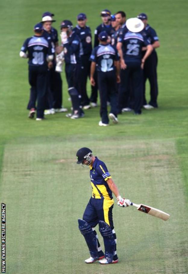 Glamorgan batsman Chris Cooke trudges off as Northants players celebrate his wicket in the FLt20 clash at the Swalec Stadium.