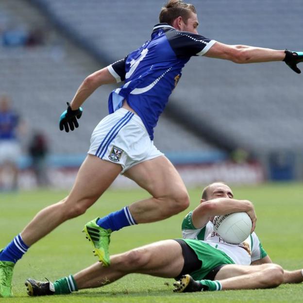 Cavan midfielder David Givney moves in as Caolan Doyle of London clings to the ball on the ground of Croke Park