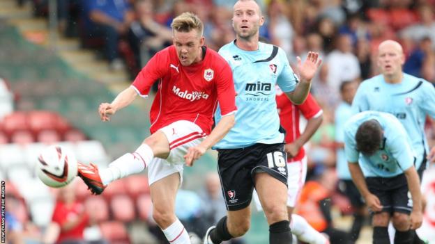 Craig Noone fires a shot at goal as Cardiff City continued their preparations for the Premier League season with a 1-1 draw at Cheltenham Town.