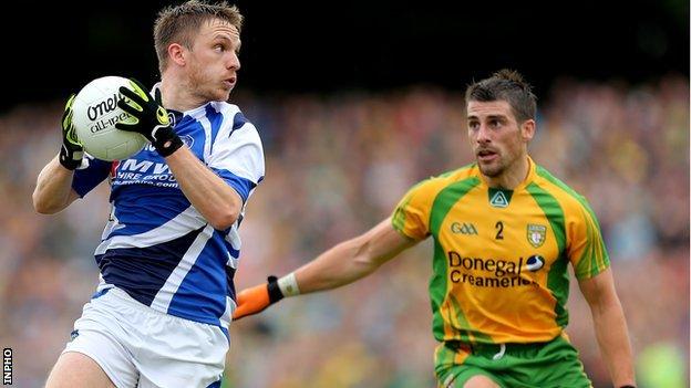 Ross Munnelly of Laois in possession against Paddy McGrath of Donegal