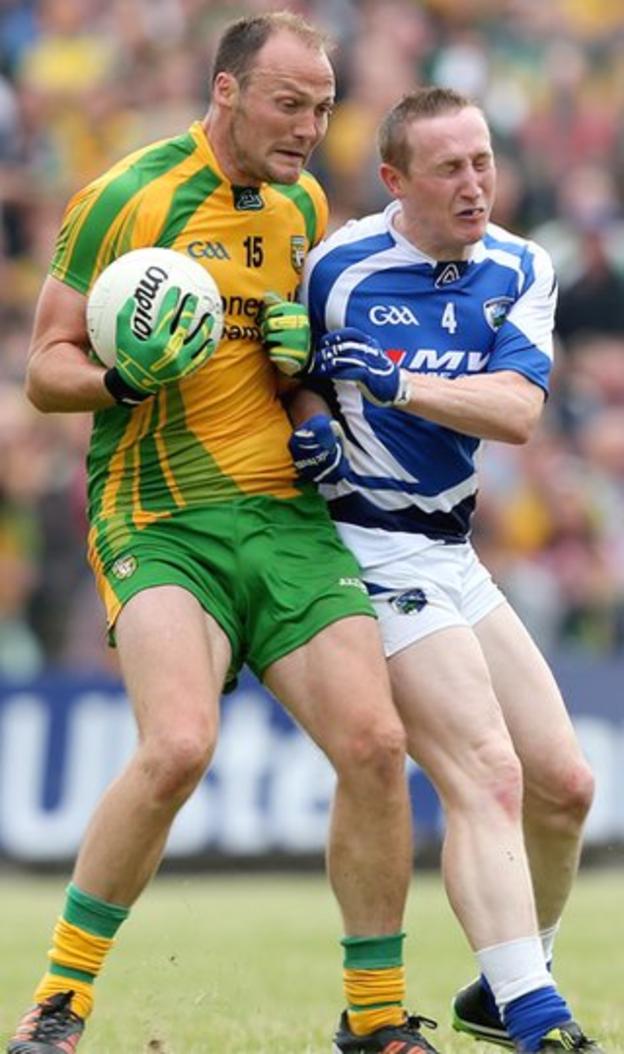 Donegal forward Colm McFadden collides with Laois defender Peter O'Leary