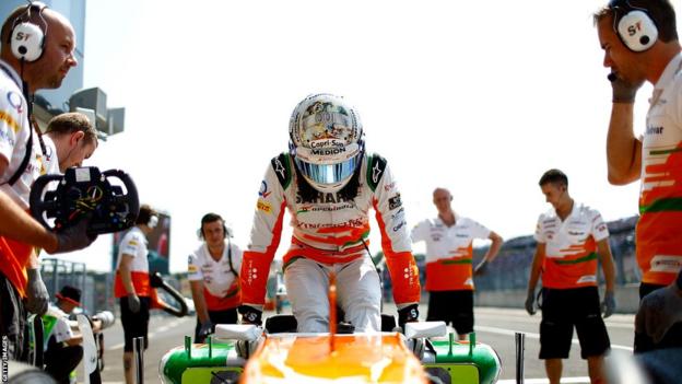 Adrian Sutil steps out of his Force India car