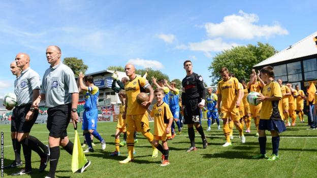 Newport County and Accrington Stanley players are led out onto the Rodney Parade pitch ahead of the home side’s return to the Football League after a 25-year absence.