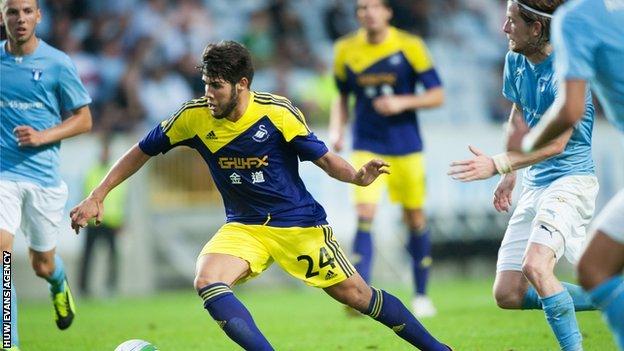 Swansea's Alejandro Pozuelo takes on the Malmo defence