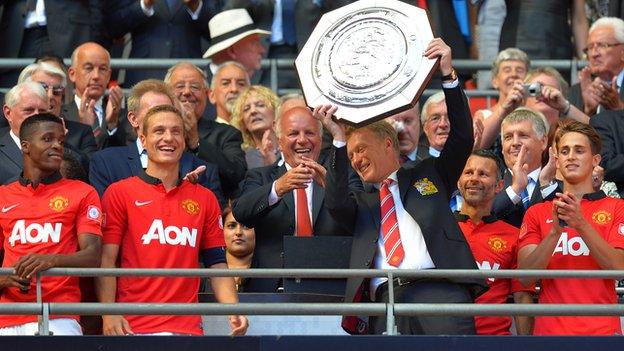 Manchester United manager David lifts the Community Shield after his side beat Wigan
