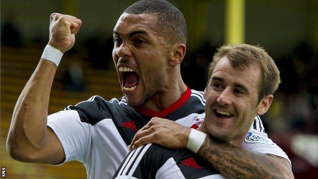 Josh Magennis congratulates Niall McGinn on one of his two goals in the win at Motherwell
