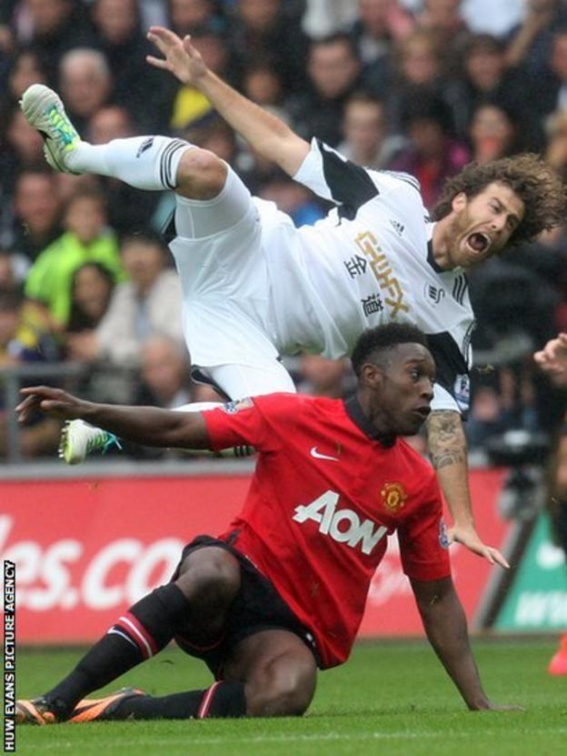 Manchester United's Danny Welbeck brings down Swansea City's Jose Canas in the Premier League at the Liberty Stadium