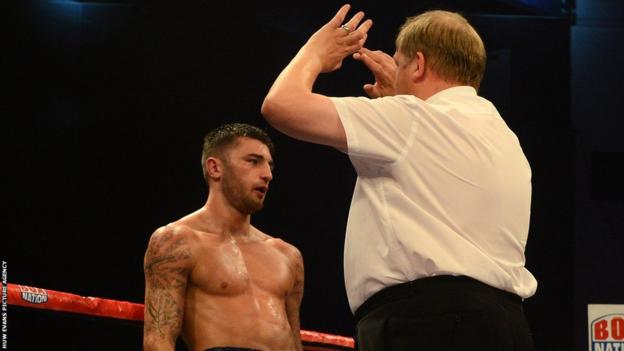 Referee Terry O'Connor steps in to halt further punishment to Cleverly in the fourth round